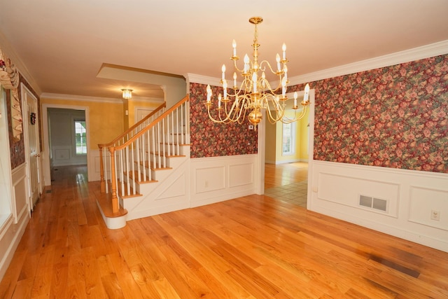 106 Jenkins Rd, Bedford, NH 03110 - unfurnished dining area featuring plenty of natural light, wainscoting, a chandelier, stairs, and light wood-type flooring