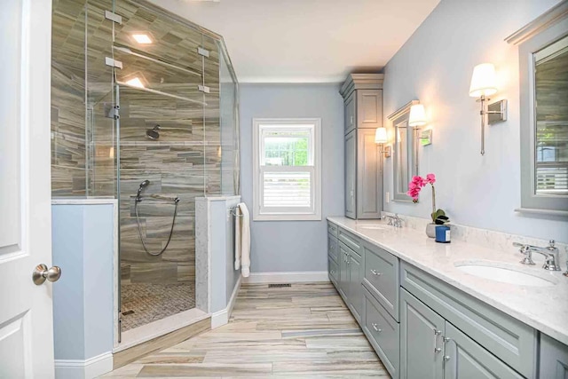 12 Haywick Dr, Stratham, NH 03870 - bathroom with double vanity, a shower stall, and baseboards