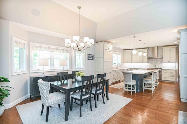 12 Haywick Dr, Stratham, NH 03870 - dining room featuring a chandelier, plenty of natural light, dark wood-style flooring, baseboards, and lofted ceiling