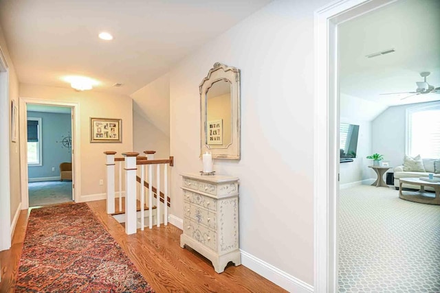 12 Haywick Dr, Stratham, NH 03870 - corridor with an upstairs landing, lofted ceiling, light wood-style flooring, baseboards, and recessed lighting