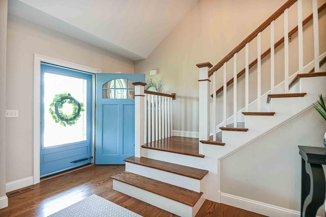 12 Haywick Dr, Stratham, NH 03870 - foyer entrance with stairway, wood finished floors, baseboards, and high vaulted ceiling