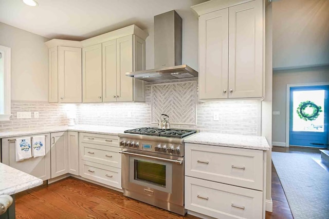 12 Haywick Dr, Stratham, NH 03870 - kitchen featuring high end stainless steel range oven, wall chimney range hood, light stone counters, backsplash, and white cabinets