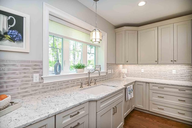 12 Haywick Dr, Stratham, NH 03870 - kitchen featuring a sink, decorative light fixtures, tasteful backsplash, light stone countertops, and dark wood-style flooring