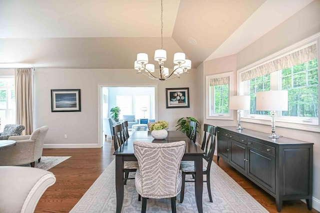 12 Haywick Dr, Stratham, NH 03870 - dining room with a chandelier, lofted ceiling, dark wood-style flooring, and baseboards