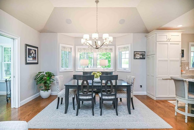 12 Haywick Dr, Stratham, NH 03870 - dining space with a chandelier, vaulted ceiling, wood finished floors, and baseboards