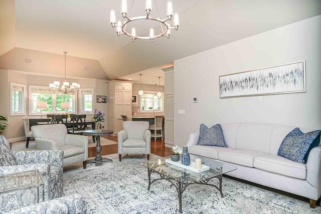 12 Haywick Dr, Stratham, NH 03870 - living room featuring a chandelier, baseboards, and a tray ceiling