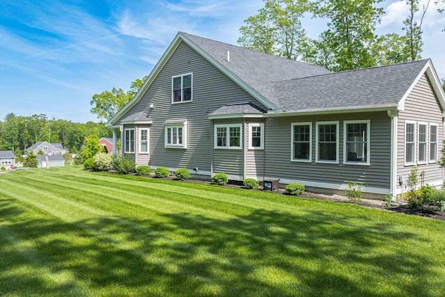 12 Haywick Dr, Stratham, NH 03870 - rear view of property with a lawn and a shingled roof
