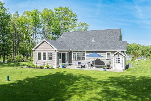12 Haywick Dr, Stratham, NH 03870 - back of property featuring a patio area, central AC, a lawn, and roof with shingles