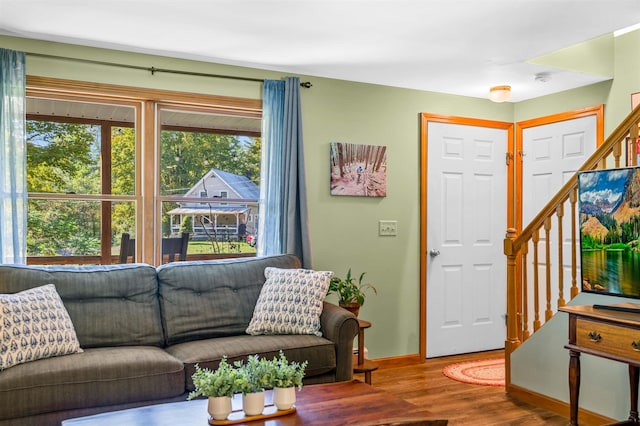 354 Jenny Davis Rd, Waterbury, VT 05676 - living area featuring healthy amount of natural light, wood finished floors, stairway, and baseboards