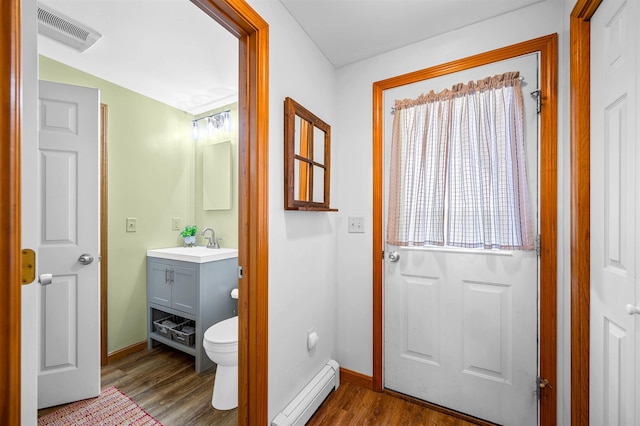354 Jenny Davis Rd, Waterbury, VT 05676 - bathroom featuring a baseboard radiator, vanity, baseboards, and wood finished floors