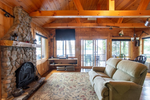 376 White Oak Rd, Barnstead, NH 03225 - living room with wood ceiling, wood walls, light wood-type flooring, and a stone fireplace