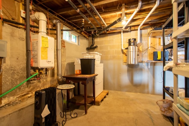 376 White Oak Rd, Barnstead, NH 03225 - below grade area with washer and clothes dryer, a central vacuum unit, and tankless water heater