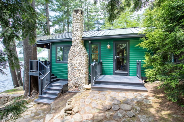 376 White Oak Rd, Barnstead, NH 03225 - back of property featuring a standing seam roof, metal roof, and a chimney