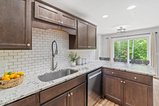 16 Ches Mae Ln, Milford, NH 03055 - kitchen featuring stainless steel dishwasher, a sink, a peninsula, light wood finished floors, and backsplash