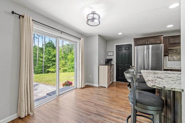 16 Ches Mae Ln, Milford, NH 03055 - kitchen with baseboards, freestanding refrigerator, dark brown cabinets, light wood-type flooring, and recessed lighting