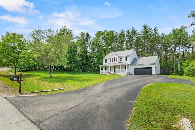 16 Ches Mae Ln, Milford, NH 03055 - view of front of property with a porch, a front lawn, an attached garage, metal roof, and driveway