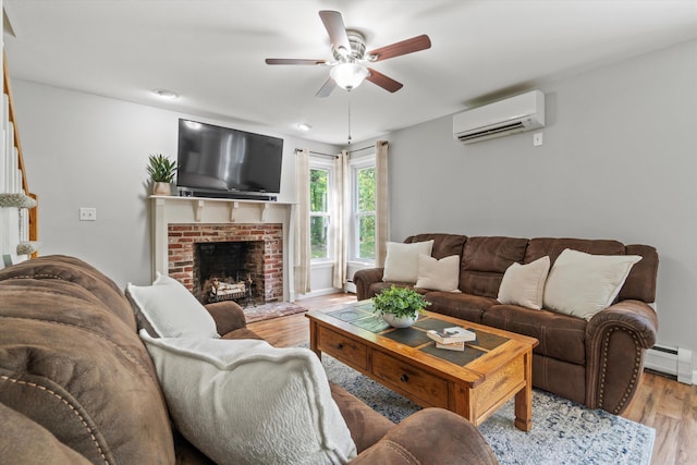 16 Ches Mae Ln, Milford, NH 03055 - living area featuring a wall mounted AC, ceiling fan, wood finished floors, a brick fireplace, and baseboard heating