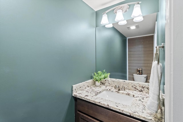 16 Ches Mae Ln, Milford, NH 03055 - bathroom with vanity, toilet, and wood walls