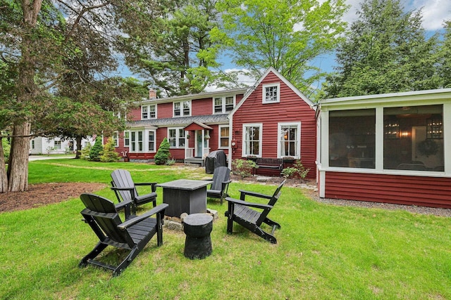 26 Middle St, Amherst, NH 03031 - rear view of property featuring a yard, an outdoor fire pit, and a chimney