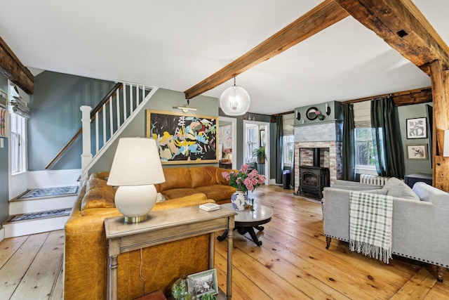 26 Middle St, Amherst, NH 03031 - living room with a wood stove, stairway, beamed ceiling, and wood-type flooring