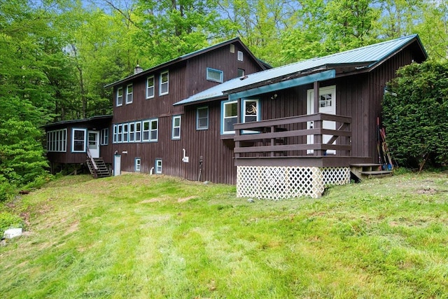 135 Governor Peck Rd, Jericho, VT 05465 - back of property featuring a yard, a wooden deck, a sunroom, and metal roof