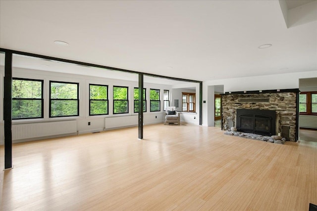 135 Governor Peck Rd, Jericho, VT 05465 - unfurnished living room featuring radiator heating unit, wood finished floors, and healthy amount of natural light