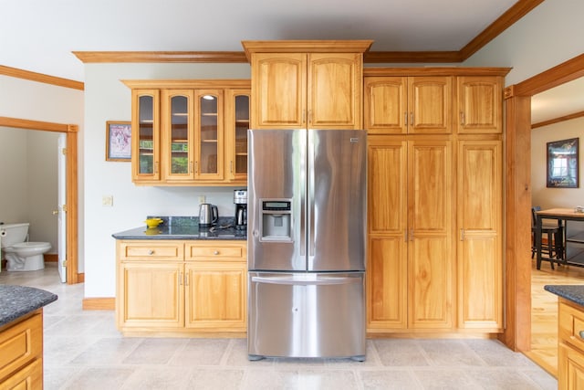 275 Petit Rd, Coventry, VT 05825 - kitchen with stainless steel fridge, crown molding, glass insert cabinets, dark stone counters, and baseboards