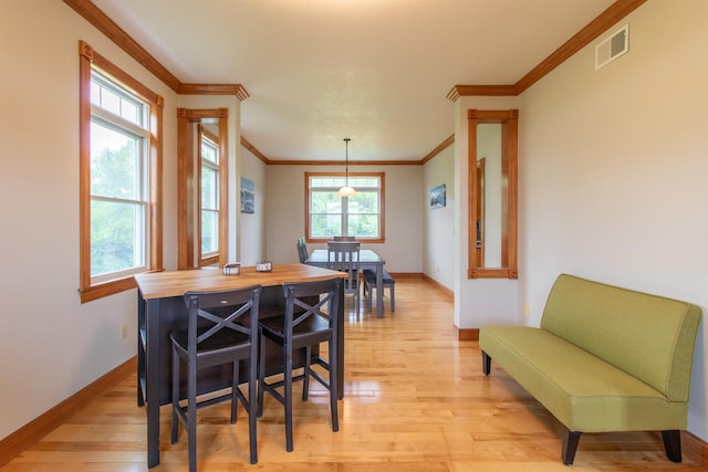 275 Petit Rd, Coventry, VT 05825 - dining area with ornamental molding, light wood-style floors, and baseboards