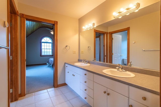 275 Petit Rd, Coventry, VT 05825 - ensuite bathroom featuring double vanity, tile patterned floors, baseboards, and ceiling fan