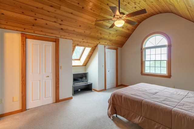 275 Petit Rd, Coventry, VT 05825 - carpeted bedroom with vaulted ceiling, a skylight, baseboards, a ceiling fan, and wood ceiling