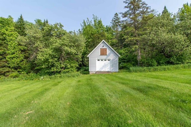 275 Petit Rd, Coventry, VT 05825 - view of green lawn featuring a detached garage and a view of trees