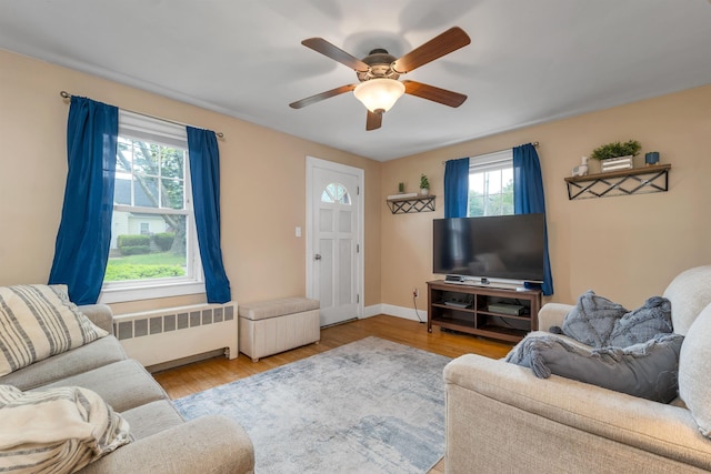 190 Anthony St, Manchester, NH 03103 - living area with radiator, a ceiling fan, and wood finished floors