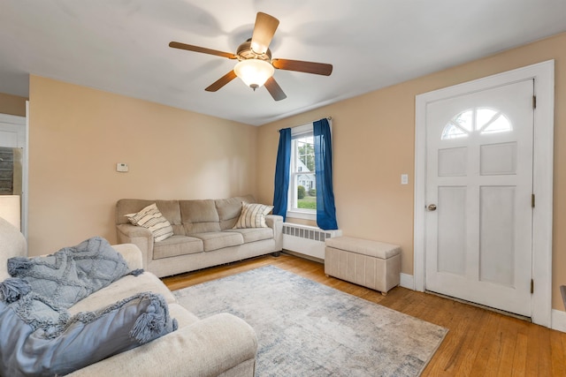 190 Anthony St, Manchester, NH 03103 - living area featuring radiator heating unit, ceiling fan, wood finished floors, and baseboards