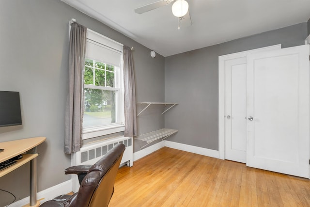 190 Anthony St, Manchester, NH 03103 - home office with radiator, baseboards, light wood finished floors, and a ceiling fan