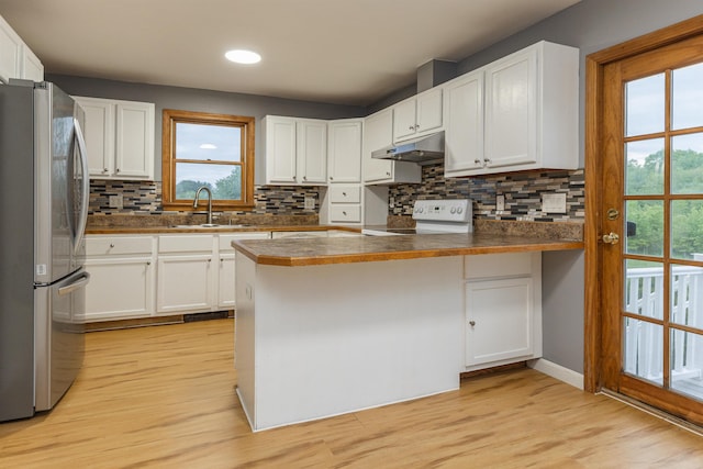62 Indigo Hill Rd, Somersworth, NH 03878 - kitchen with freestanding refrigerator, white electric range, a sink, a peninsula, and dark countertops