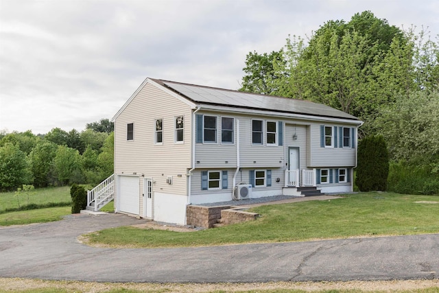 62 Indigo Hill Rd, Somersworth, NH 03878 - bi-level home featuring an attached garage, driveway, a front lawn, and solar panels
