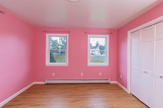 62 Indigo Hill Rd, Somersworth, NH 03878 - unfurnished bedroom featuring light wood-style flooring, baseboard heating, baseboards, and a closet