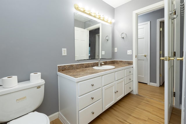 62 Indigo Hill Rd, Somersworth, NH 03878 - half bath featuring vanity, wood finished floors, toilet, and baseboards