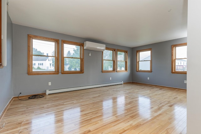 62 Indigo Hill Rd, Somersworth, NH 03878 - spare room with a baseboard heating unit, a wall mounted air conditioner, wood finished floors, and baseboards