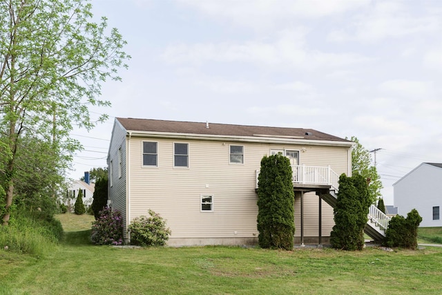 62 Indigo Hill Rd, Somersworth, NH 03878 - back of property with a yard, stairway, and a deck