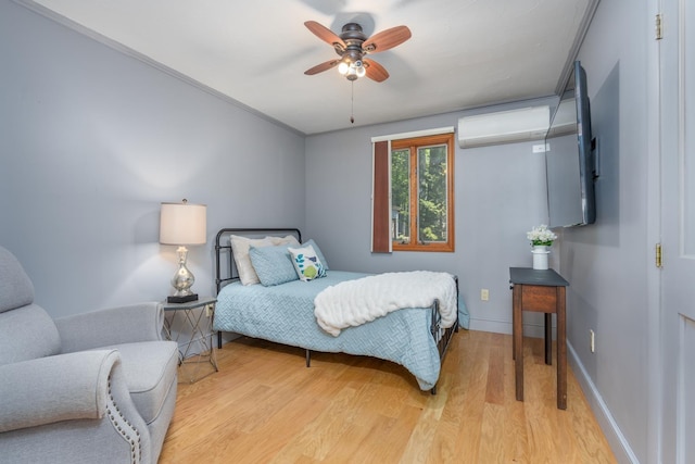 26 Association Dr, Northwood, NH 03261 - bedroom featuring a wall mounted air conditioner, light wood-style floors, baseboards, and ceiling fan