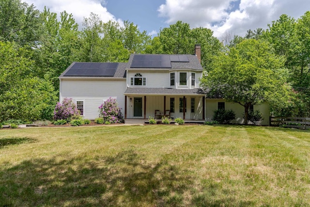 11 Rabbit Ln, Barrington, NH 03825 - view of front of property featuring a chimney, covered porch, solar panels, and a shingled roof