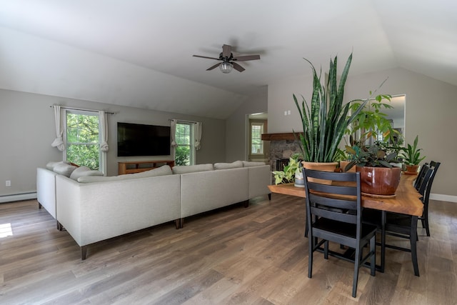 11 Rabbit Ln, Barrington, NH 03825 - dining space featuring vaulted ceiling, ceiling fan, wood finished floors, a fireplace, and baseboard heating