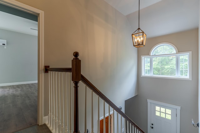 11 Rabbit Ln, Barrington, NH 03825 - stairway featuring a chandelier, wood finished floors, and baseboards