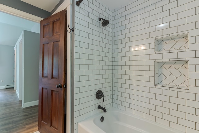 11 Rabbit Ln, Barrington, NH 03825 - bathroom featuring shower / bath combination, a baseboard radiator, wood finished floors, and baseboards