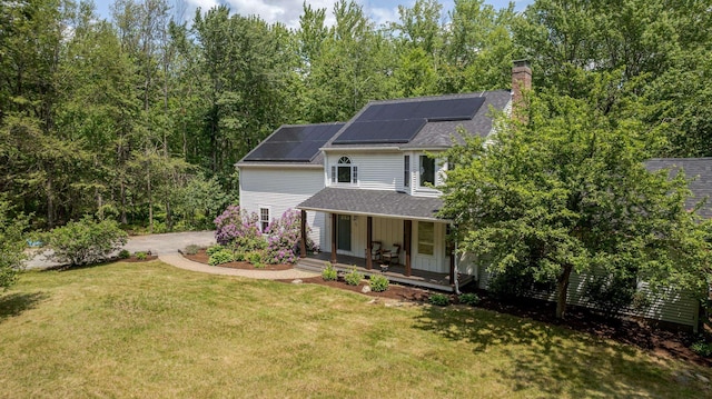 11 Rabbit Ln, Barrington, NH 03825 - view of front of house with covered porch, a front lawn, solar panels, a chimney, and a shingled roof