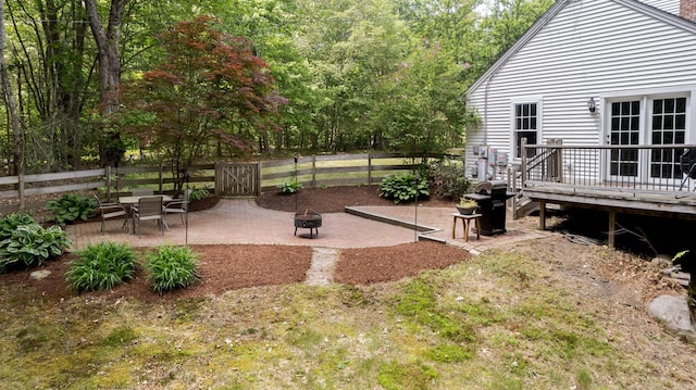 11 Rabbit Ln, Barrington, NH 03825 - fenced backyard featuring a fire pit, a deck, and a patio