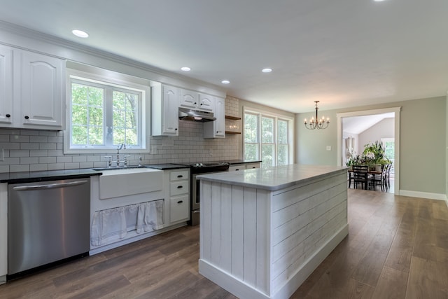 11 Rabbit Ln, Barrington, NH 03825 - kitchen featuring stainless steel appliances, under cabinet range hood, a sink, a chandelier, and white cabinetry