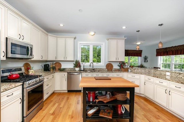 38 Granite Ln Unit 38, Chester, NH 03036 - kitchen with stainless steel appliances, butcher block countertops, light wood-type flooring, open shelves, and a sink