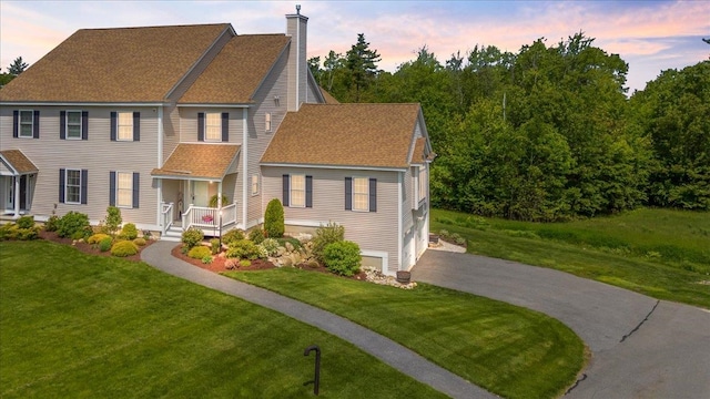 38 Granite Ln Unit 38, Chester, NH 03036 - colonial-style house with asphalt driveway, a chimney, a lawn, and roof with shingles